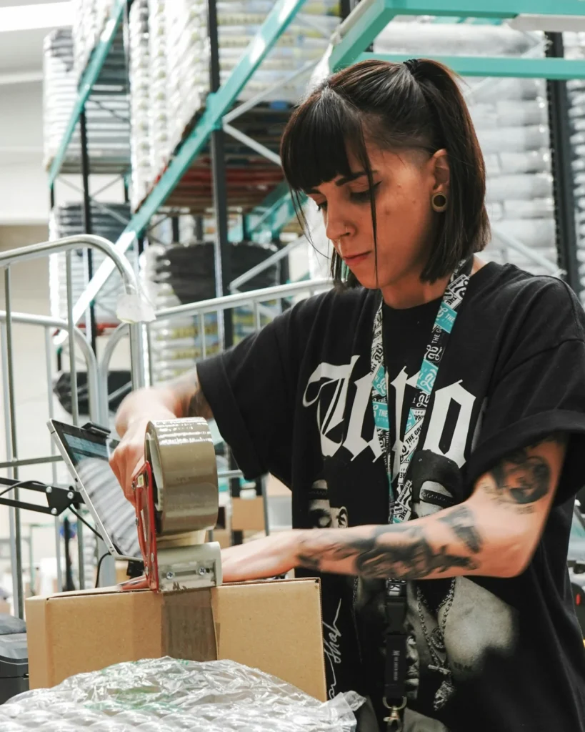 Store worker taping up an order in a warehouse
