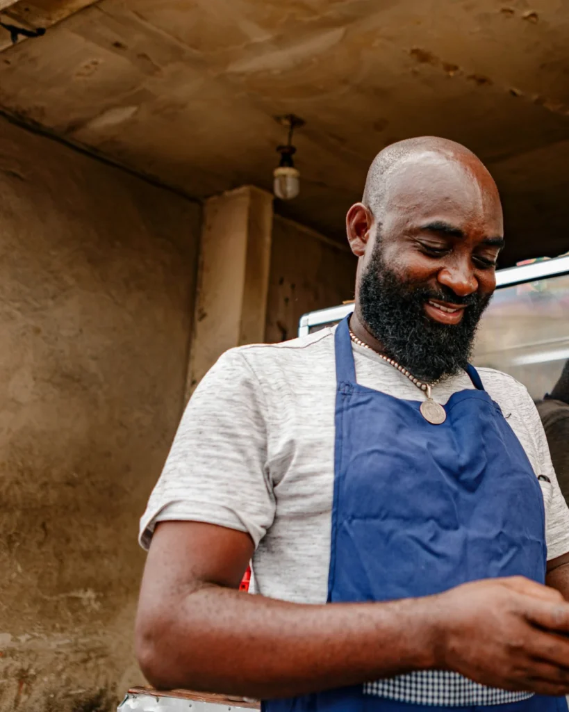 Local shop owner checking his phone behind the counter