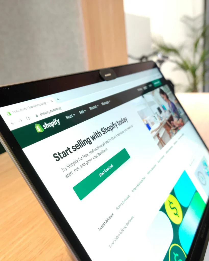 Laptop showing the Shopify website on a desk