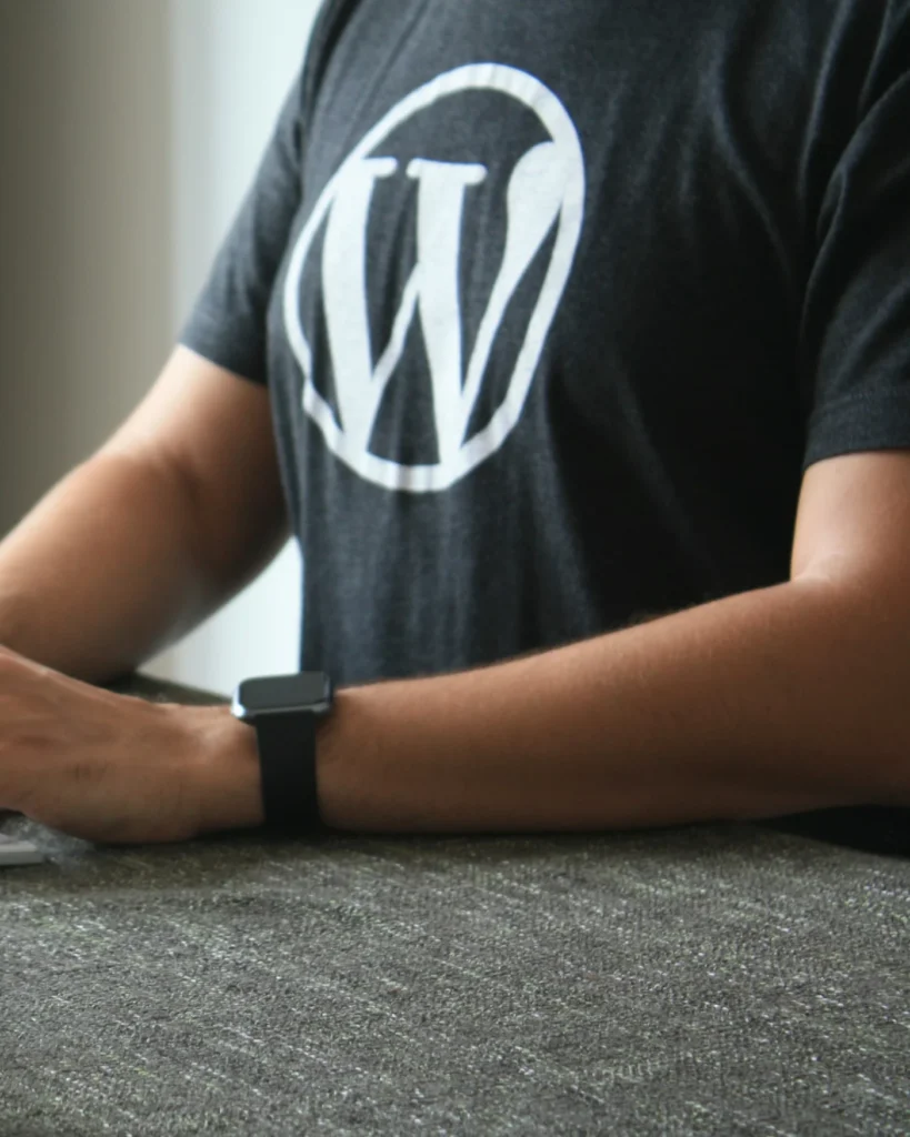 Developer in a WordPress T-shirt working at a desk